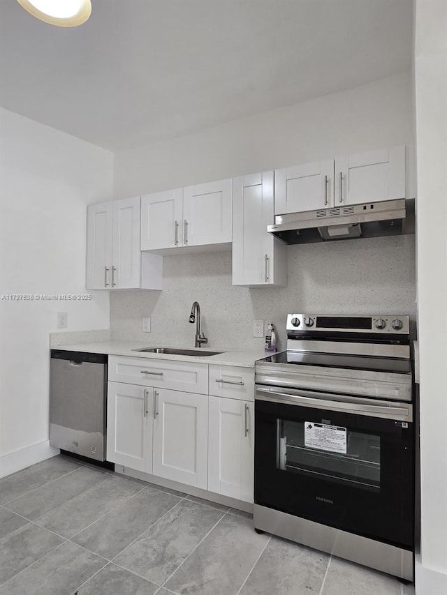 kitchen with white cabinetry, sink, decorative backsplash, and stainless steel appliances