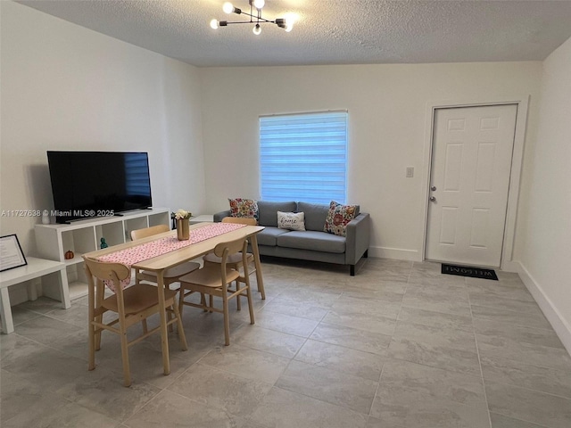 dining area featuring a textured ceiling