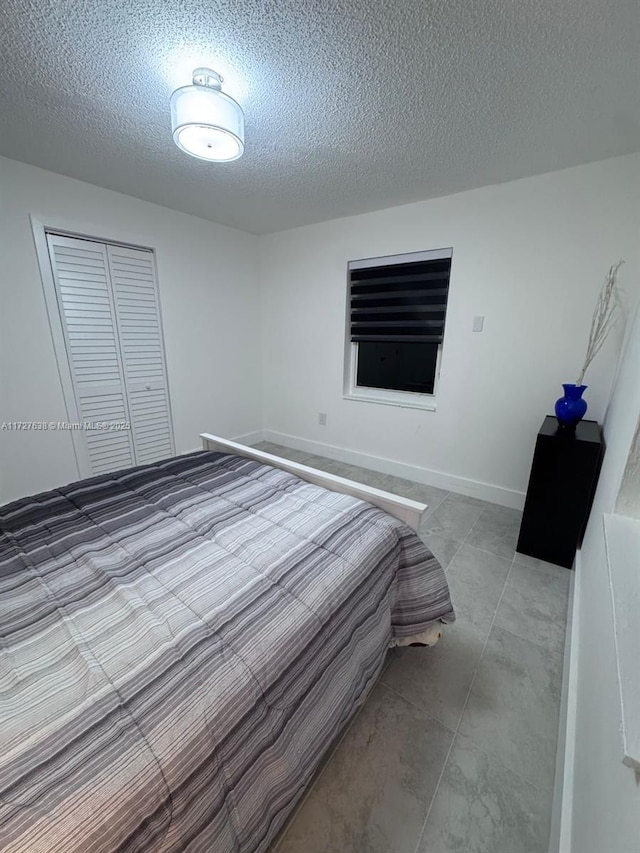 unfurnished bedroom featuring a closet and a textured ceiling