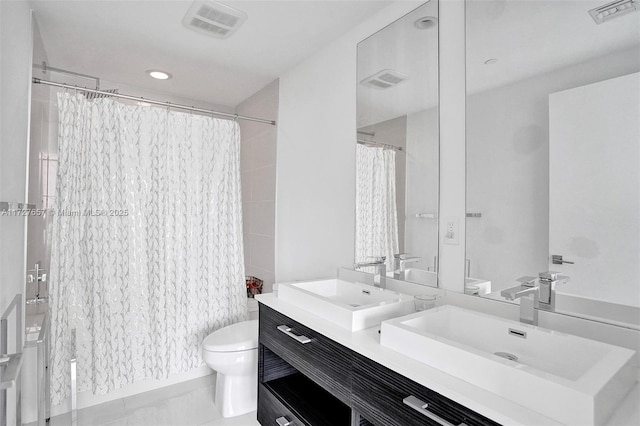 bathroom with toilet, tile patterned flooring, vanity, and curtained shower