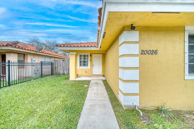 entrance to property featuring a yard