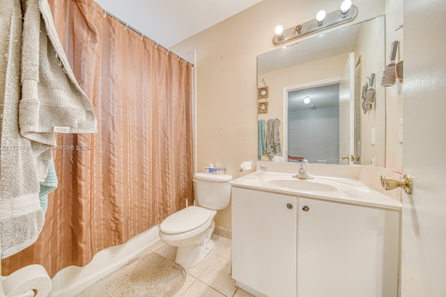 full bathroom featuring vanity, tile patterned floors, shower / bath combo with shower curtain, and toilet