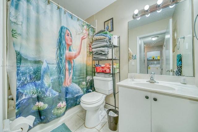 bathroom with vanity, tile patterned floors, toilet, and walk in shower