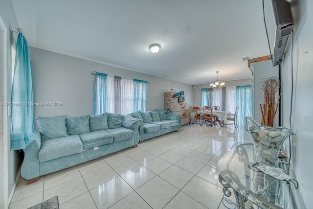 living room featuring light tile patterned floors and a chandelier