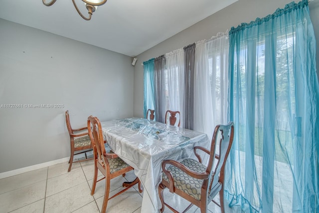 tiled dining space with vaulted ceiling