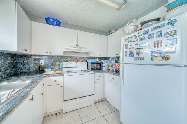 kitchen with light tile patterned floors, white appliances, backsplash, a textured ceiling, and white cabinets