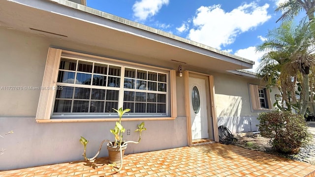 entrance to property with a patio area