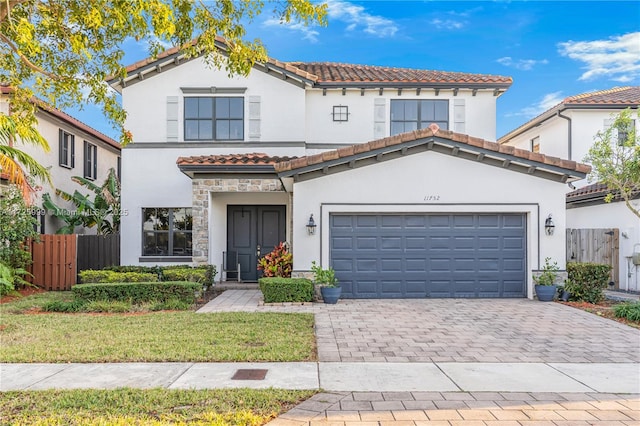 mediterranean / spanish-style house with a garage