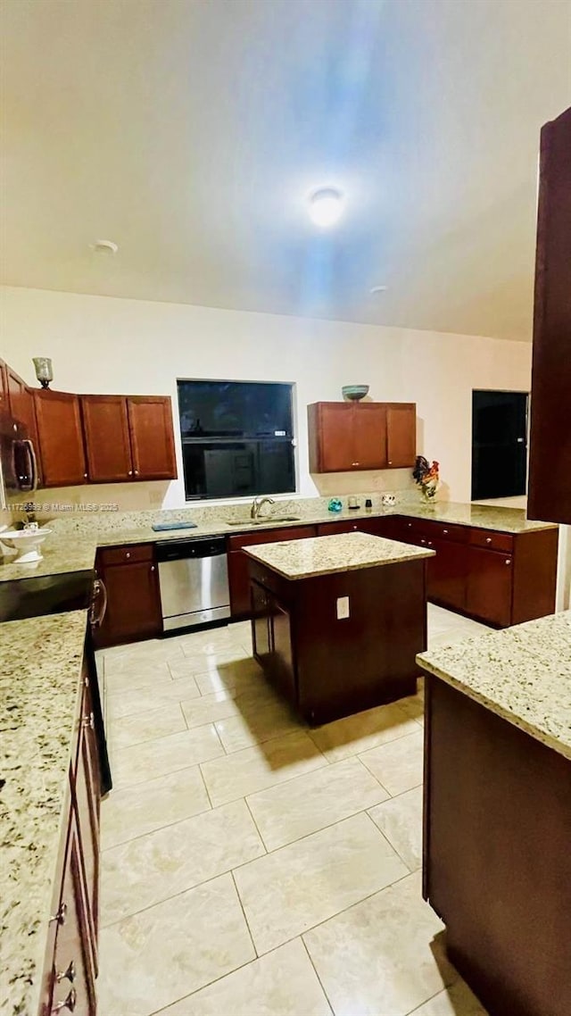 kitchen featuring light stone counters, sink, and appliances with stainless steel finishes