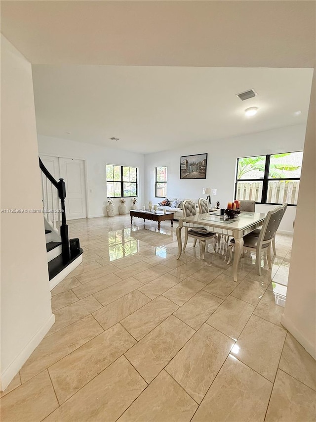 dining area with light tile patterned floors