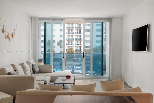 living room featuring a wealth of natural light, expansive windows, and wood-type flooring