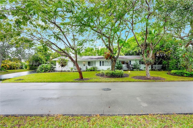 ranch-style home featuring a front yard