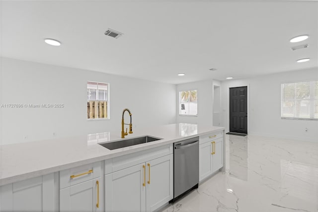 kitchen featuring light stone counters, sink, white cabinetry, and stainless steel dishwasher