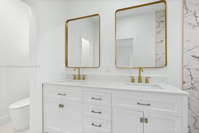 bathroom featuring toilet and vanity