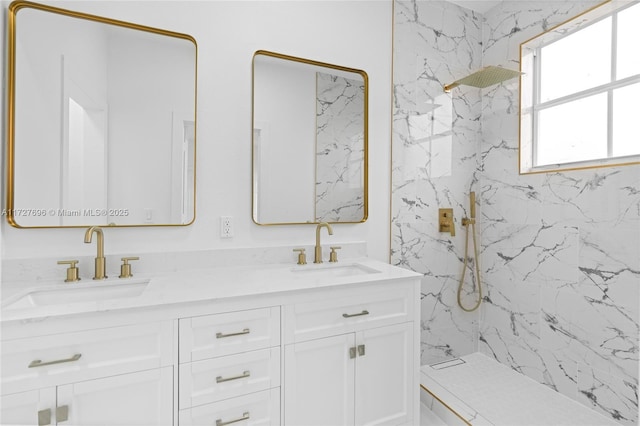 bathroom with tiled shower and vanity