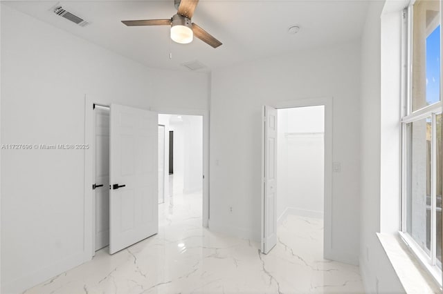 interior space with ceiling fan and multiple windows