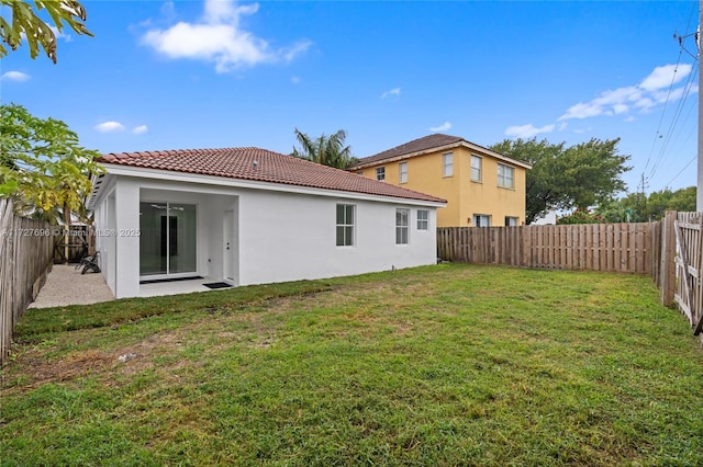 rear view of property with a lawn