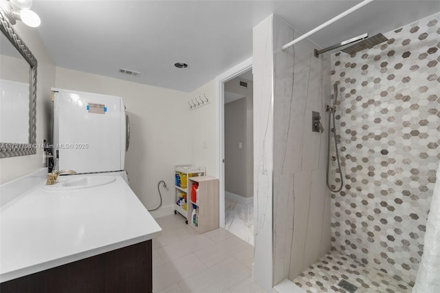 bathroom featuring walk in shower and vanity