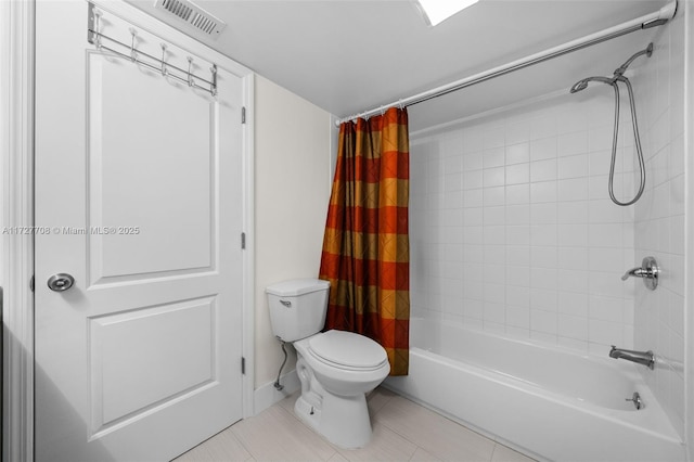 bathroom with toilet, shower / tub combo, and tile patterned floors