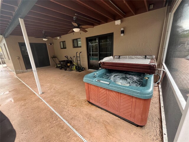 view of patio / terrace featuring ceiling fan and a hot tub