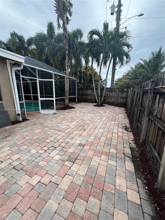 view of patio / terrace featuring a lanai