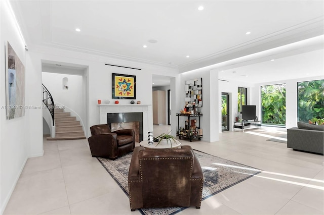 living room with light tile patterned floors, a fireplace, and crown molding