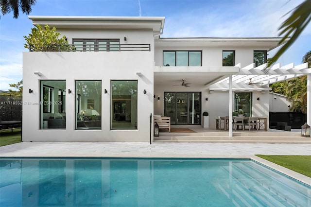 rear view of house featuring a pergola, a patio, a balcony, and ceiling fan