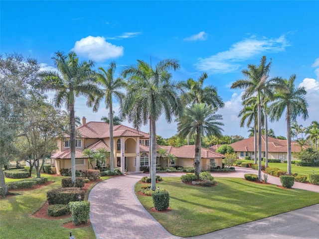 mediterranean / spanish-style home with a front yard