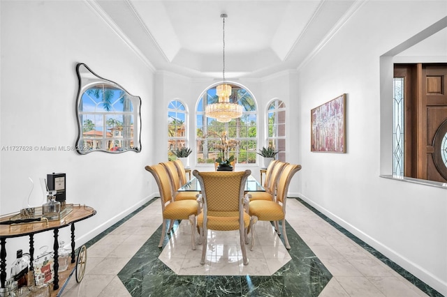 dining space with crown molding, a healthy amount of sunlight, an inviting chandelier, and a tray ceiling