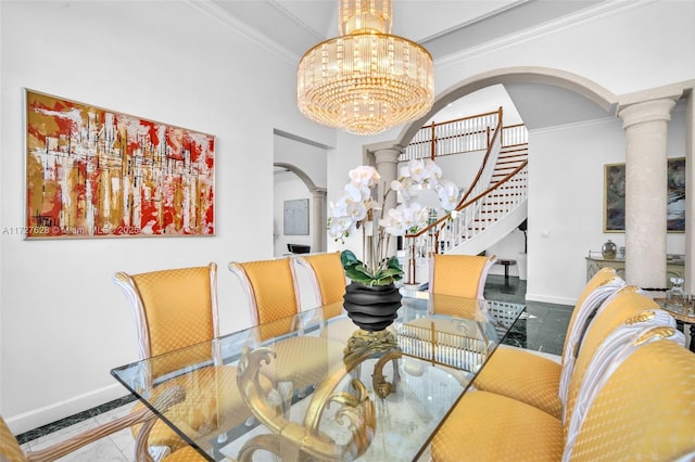 dining room featuring decorative columns, tile patterned floors, ornamental molding, and a chandelier