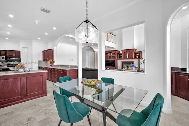 dining room featuring ornamental molding and a chandelier