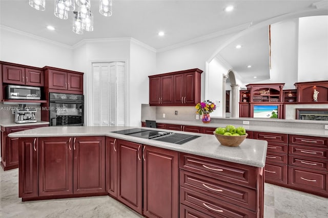 kitchen featuring a kitchen island, decorative backsplash, decorative light fixtures, ornamental molding, and black appliances