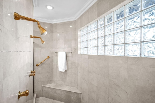 bathroom featuring ornamental molding and tiled shower