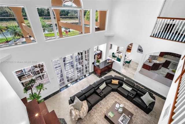 living room featuring a towering ceiling