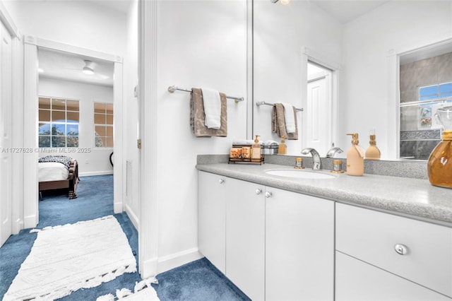 bathroom featuring a shower with door and vanity