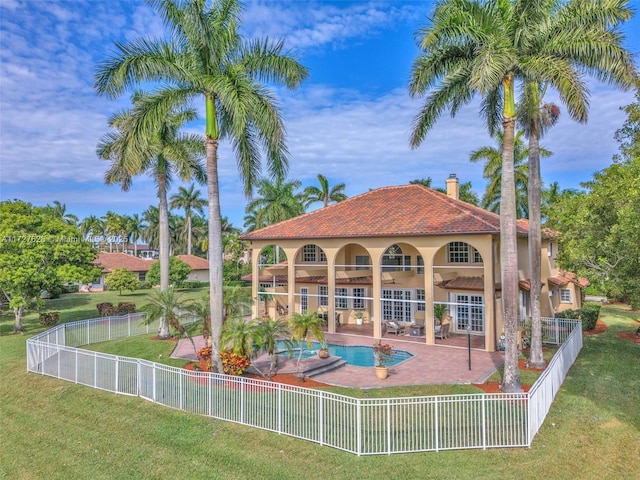 back of house with ceiling fan, a yard, a patio area, and a fenced in pool