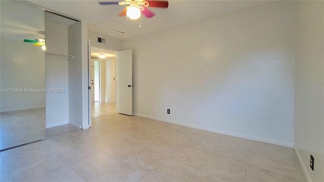 tiled spare room featuring ceiling fan