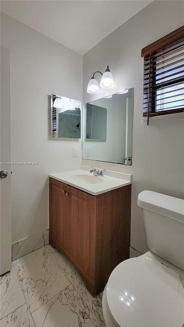 bathroom featuring toilet and vanity