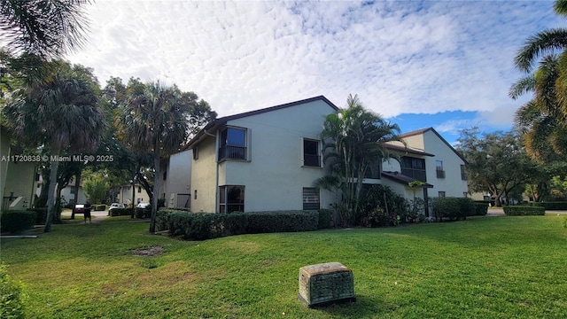 view of side of property with a yard