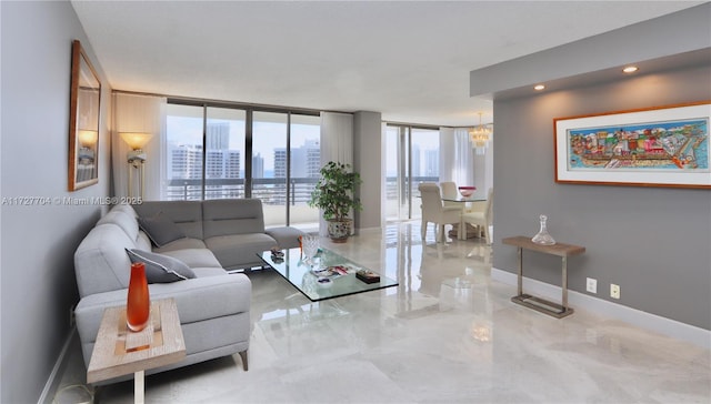 living room with an inviting chandelier and a wall of windows