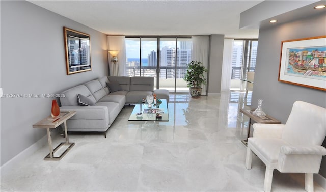 living room with a wealth of natural light and a wall of windows