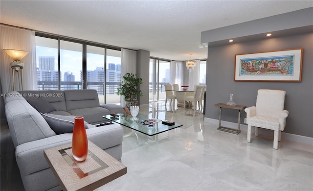 living room featuring a notable chandelier and floor to ceiling windows