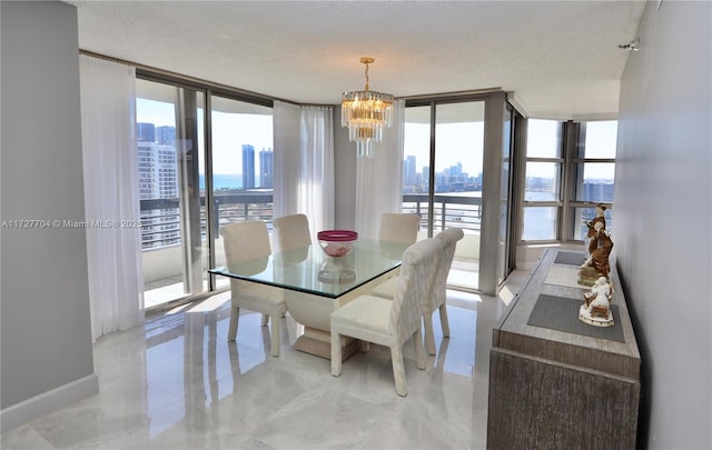 dining room featuring expansive windows, a notable chandelier, and a textured ceiling