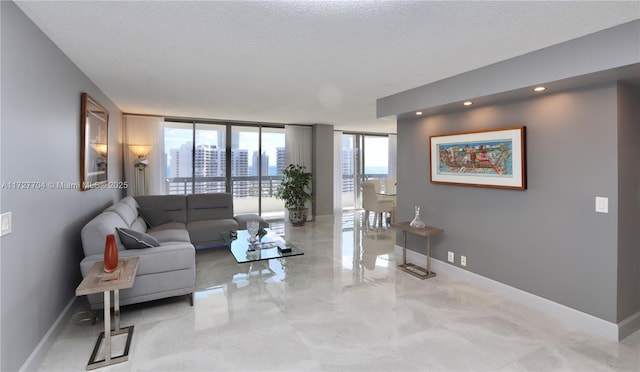 living room with expansive windows and a textured ceiling