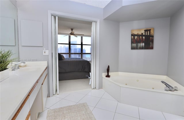 bathroom with a tub to relax in, vanity, tile patterned flooring, and ceiling fan