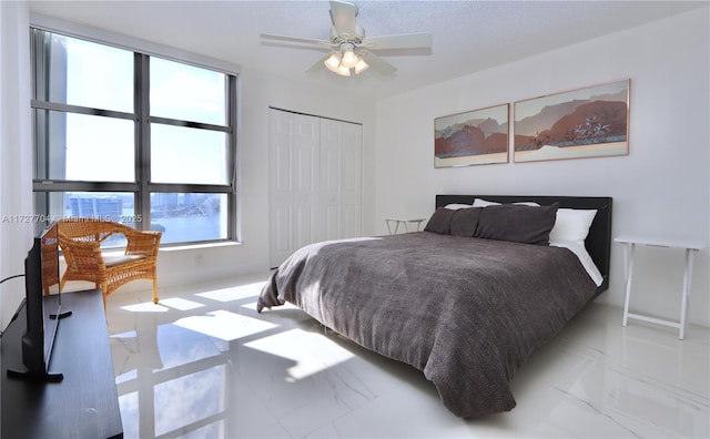 bedroom featuring ceiling fan and a closet