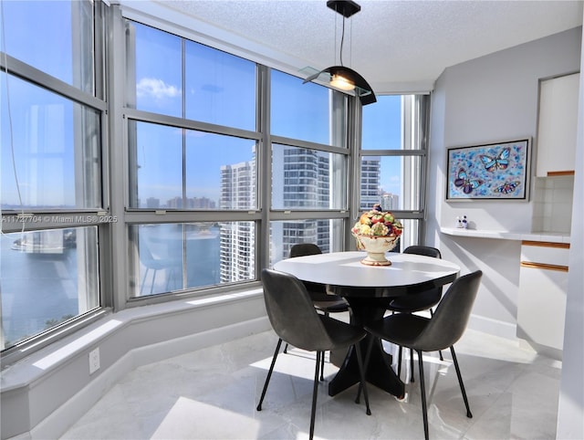 dining area featuring a textured ceiling