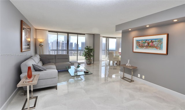 living room featuring a textured ceiling and a wall of windows