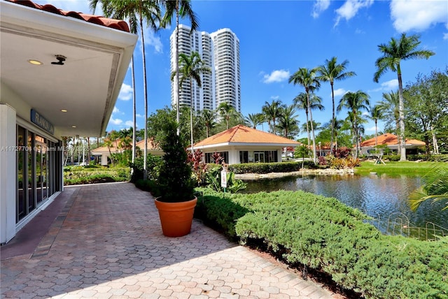 view of home's community featuring a water view and a patio