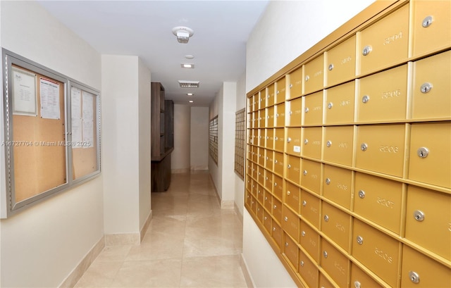 corridor with light tile patterned floors and mail boxes